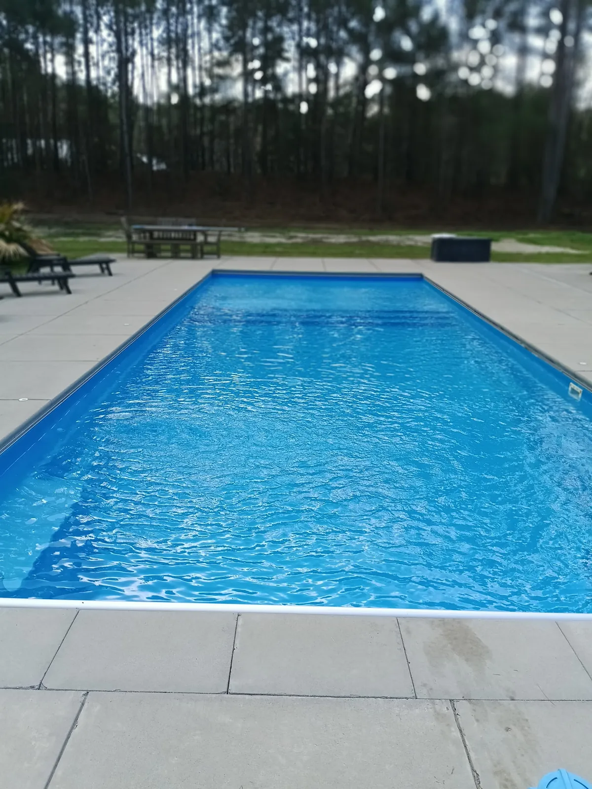 Clean fiberglass pool with concrete deck