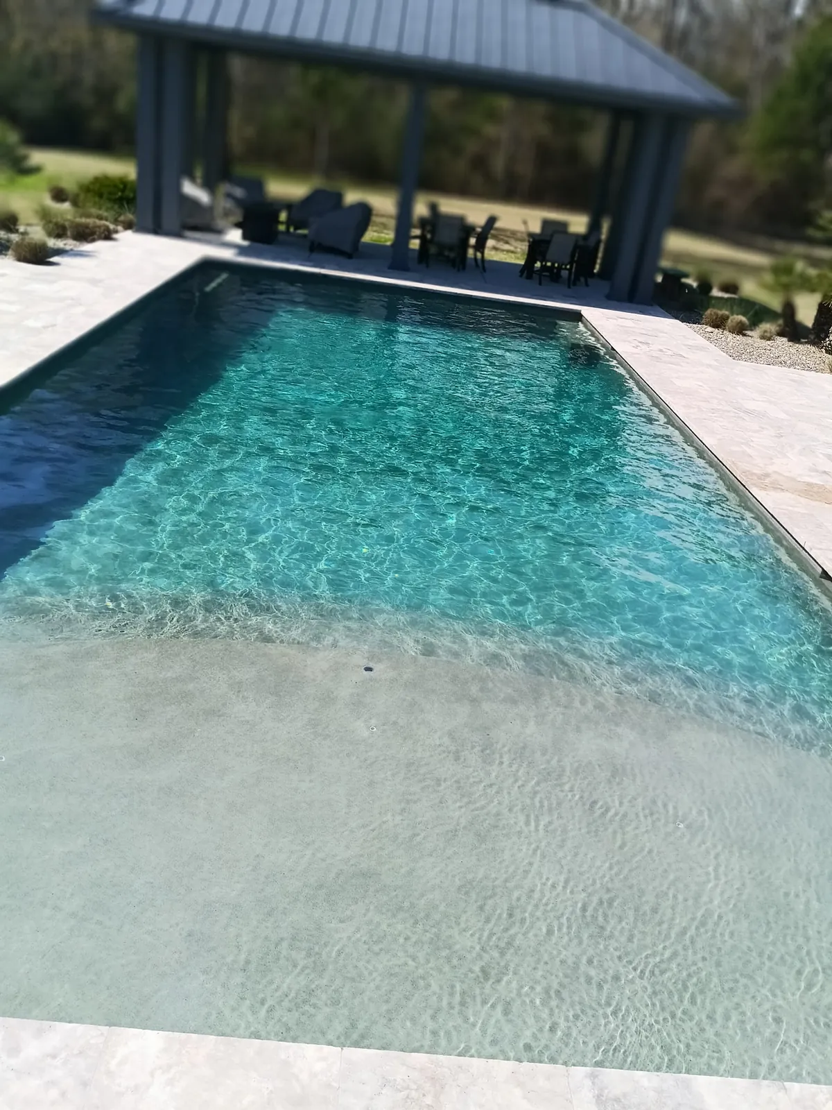 Luxury pool with tanning ledge and covered pavilion