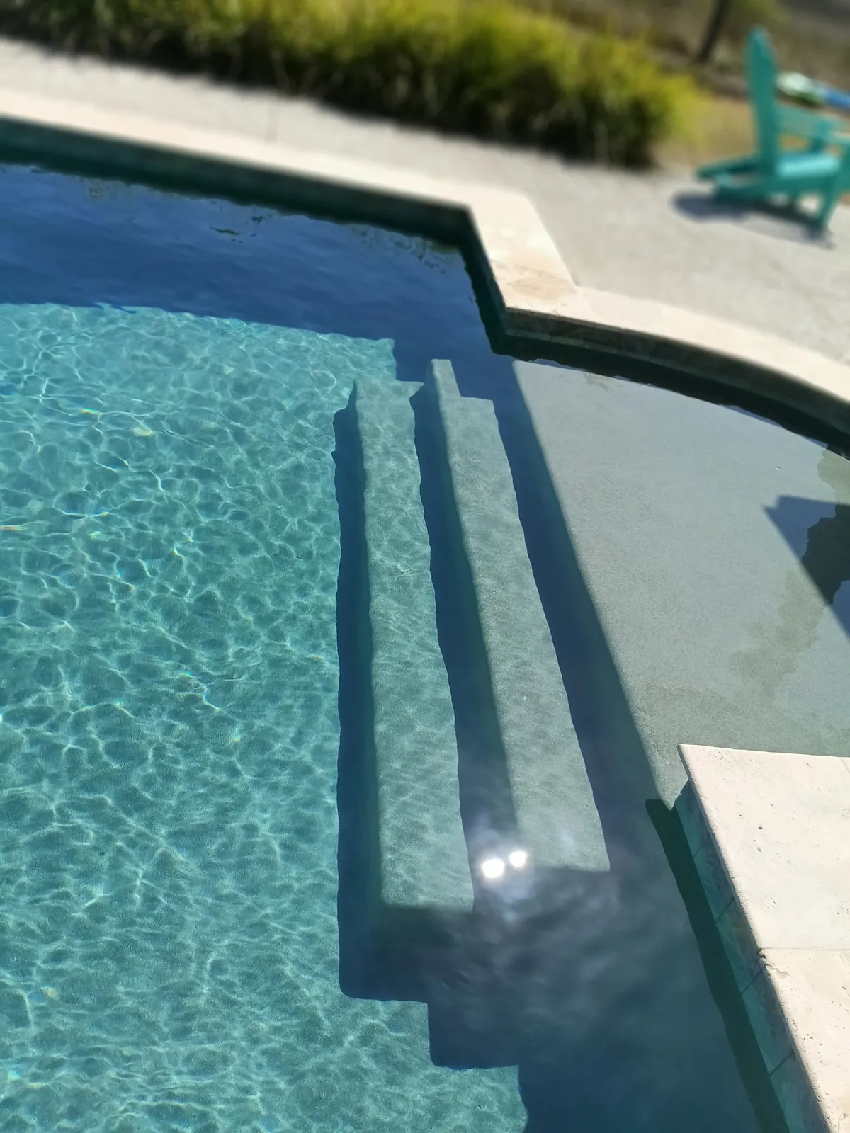 Sparkling pool with lounge chairs