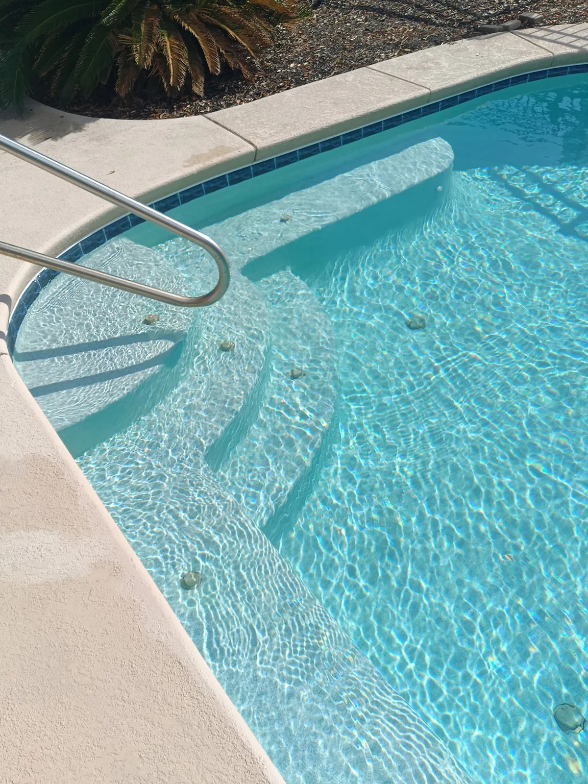 Sparkling clean pool steps and handrail detail