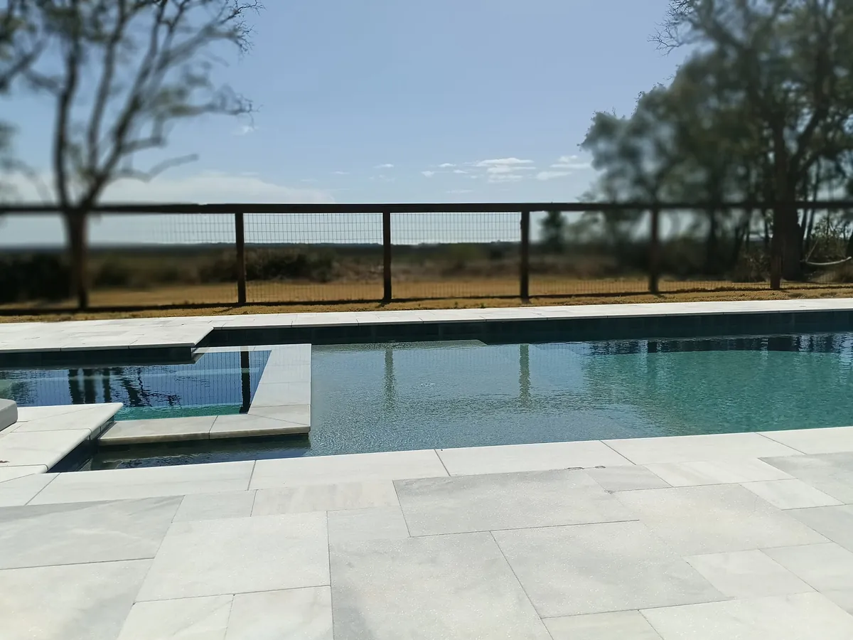 Modern pool with spa and open landscape view